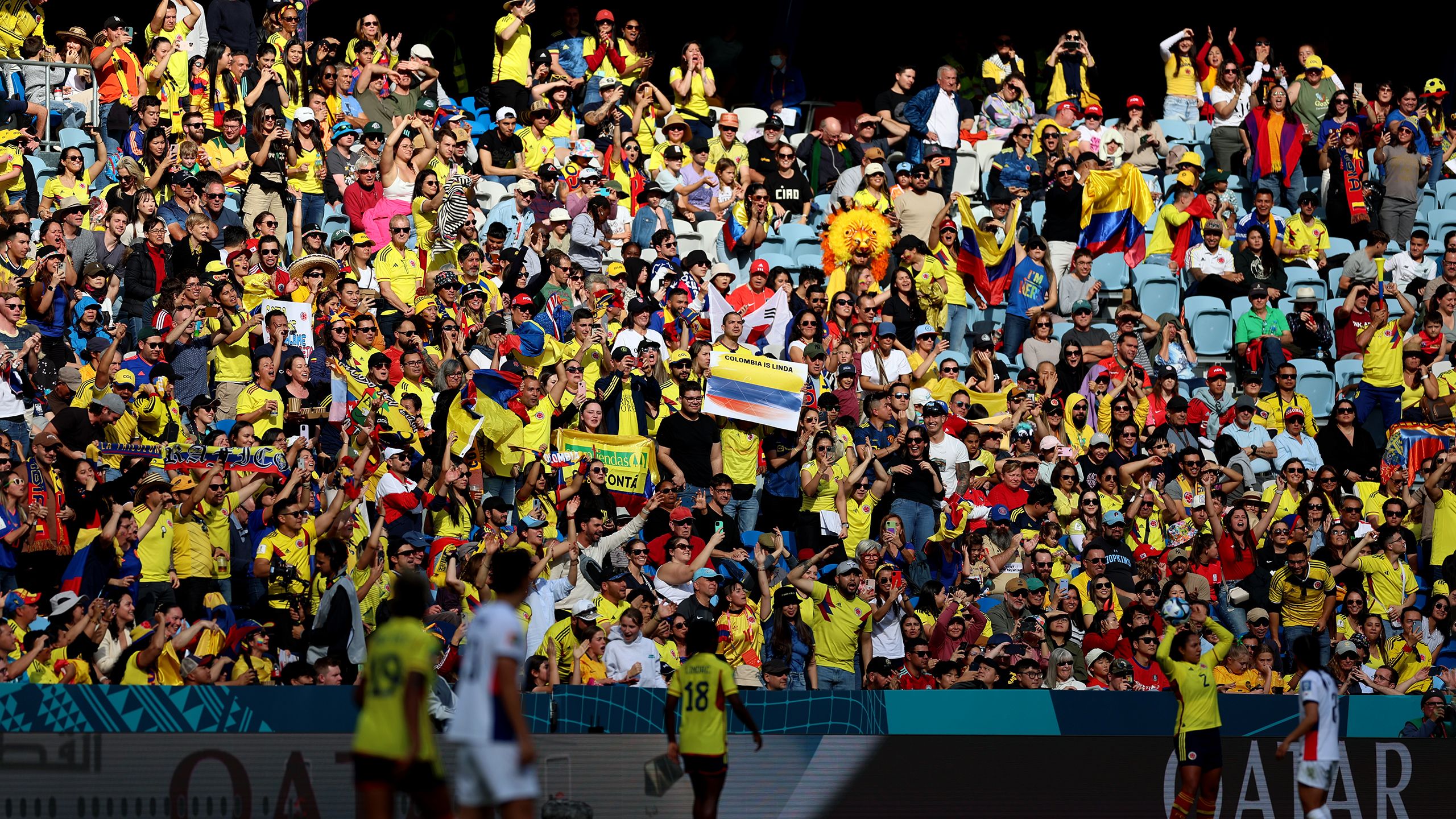 Diverse group of fans singing together at a sporting event